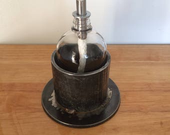 Steampunk metal base.  Heavy Industrial steel base and vintage glass bottle.