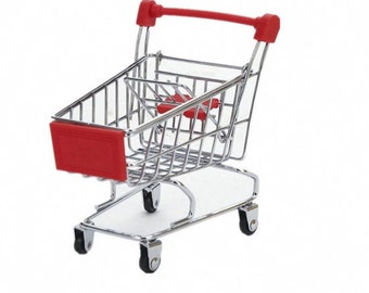 May include: A miniature shopping cart with a red handle and accents. The cart is made of shiny, silver-colored metal and has four small black wheels. The front of the cart features a red panel. The cart is designed to resemble a full-sized shopping cart.