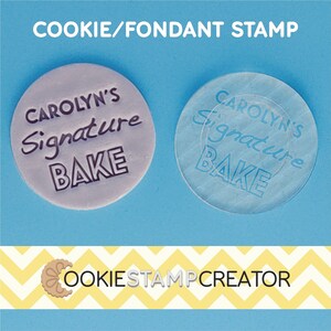 May include: A purple cookie or fondant stamp with the text "CAROLYN'S Signature BAKE" in black. The stamp is shown next to a clear silicone version of the stamp.