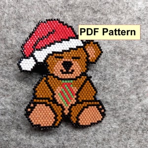 May include: A beaded Christmas ornament of a brown teddy bear wearing a red and white Santa hat and a green and red striped tie.  PDF Pattern.