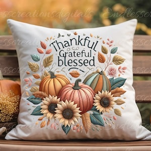 May include: White throw pillow with a Thanksgiving-themed design featuring pumpkins, sunflowers, and leaves. The text "Thankful Grateful Blessed" is printed in black on the pillow.