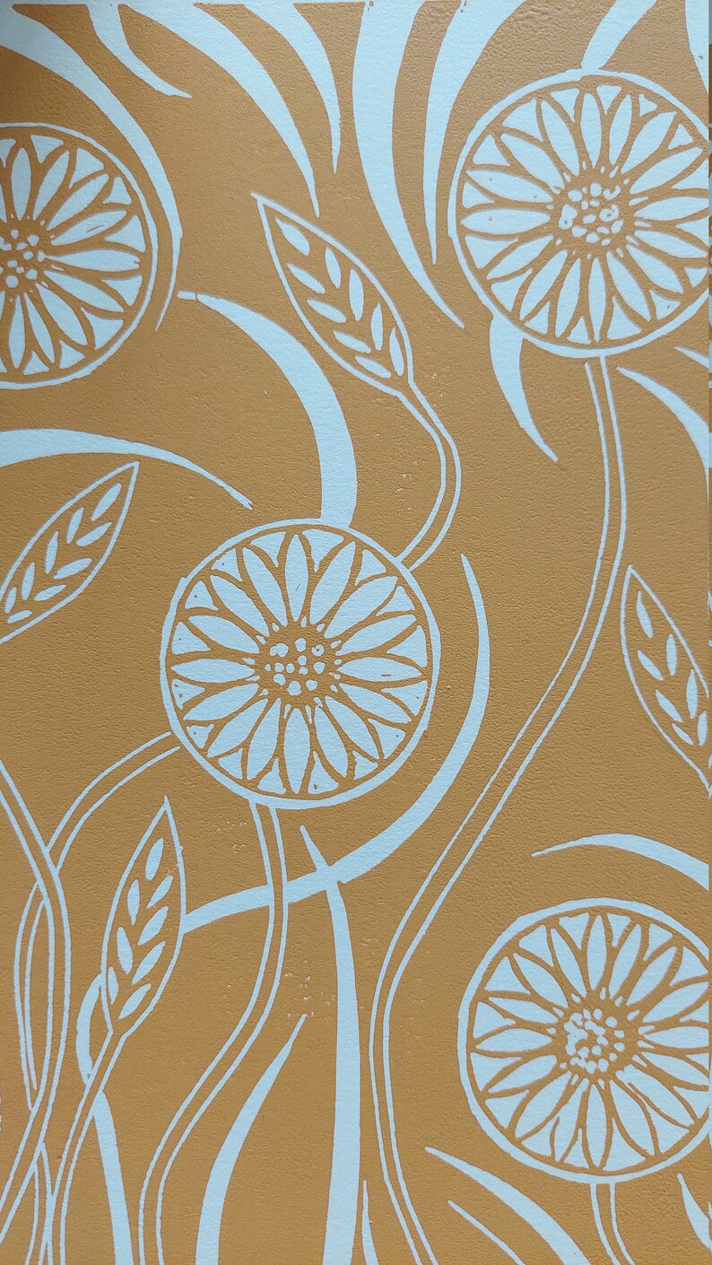 May include: A brown background with a white floral pattern. The flowers are stylized and have a circular shape with multiple petals. The background has a swirling pattern.