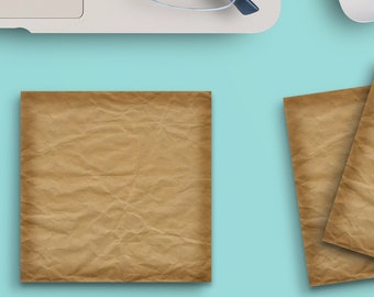 May include: A flat lay of a workspace with a laptop, a cup of coffee, a mouse, glasses, two brown paper notepads, and a set of paper clips shaped like cats on a light blue background.