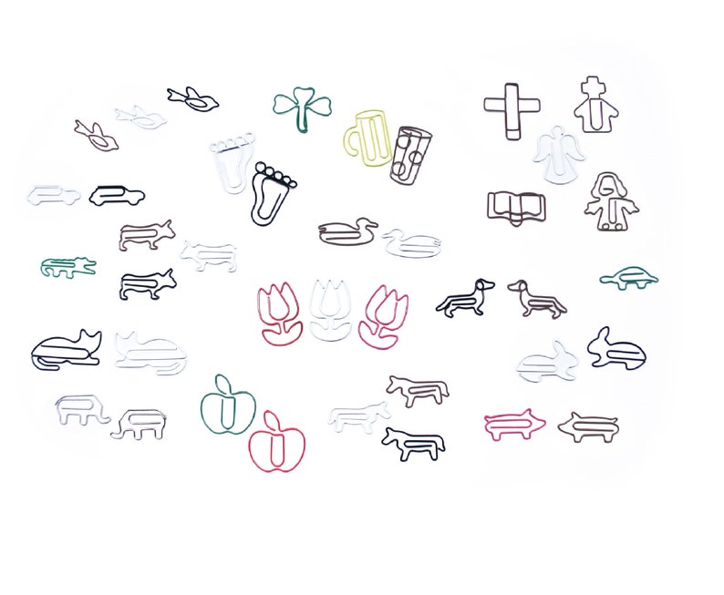 May include: A collection of colorful wire paper clips shaped like various objects, including a duck, a pig, a tulip, a cat, a cross, a book, a foot, a car, a fish, a turtle, a cow, an alligator, a beer mug, a shamrock, a bird, an angel, a person, and an apple.