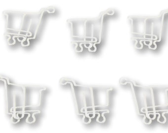 May include: Six white plastic miniature shopping carts, each with a handle and four wheels. The carts are arranged in two rows of three.