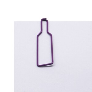 May include: Purple metal bottle shaped paper clip.