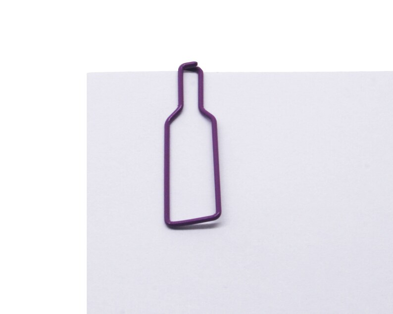 May include: Purple metal bottle shaped paper clip.
