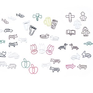 May include: A collection of colorful wire paper clips shaped like various objects, including a duck, a pig, a tulip, a cat, a fish, a cross, a book, a foot, a car, a bird, a mug, a shamrock, a turtle, an angel, a person, and a dachshund.