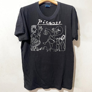 May include: A black t-shirt with a white line drawing of a Picasso painting and the word 'Picasso' printed on the front.