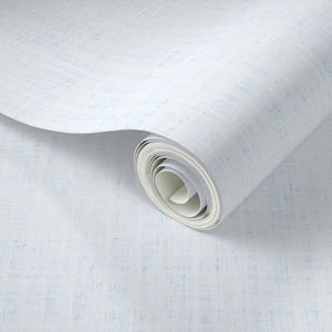 May include: A roll of white wallpaper with a subtle blue textured pattern. The wallpaper is unrolled, revealing the rolled-up portion. The design has a linen-like appearance, suitable for interior decor.