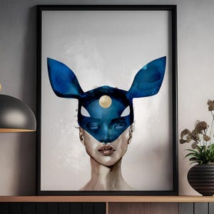 May include: A watercolor painting of a person wearing a blue mask with a gold circle in the center. The mask has large, pointed ears. The person's eyes are closed and their lips are slightly parted. The background is a light gray with a subtle texture.
