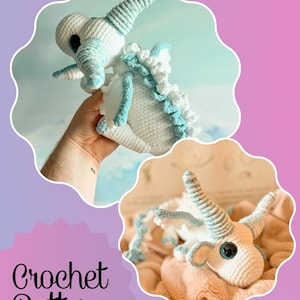 May include: A crocheted dragon toy in white and light blue. The dragon has large eyes, horns, and a frilled spine. The image also includes the text "Crochet Pattern".