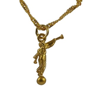 May include: Gold chain necklace with a pendant of a golden angel blowing a trumpet. The angel is standing on a round ball.
