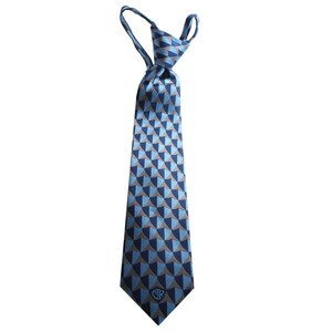 May include: A blue and gray patterned tie with a small logo in the center. The tie has a geometric pattern and is made of a silky material.