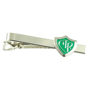 May include: Silver tie bar with a green shield-shaped charm featuring the letters "CTR" in white.