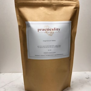 May include: A brown paper bag with a white label that says "practicality skincare" and "magnesium flakes". The label also includes instructions for use and the ingredients, which are 32 oz of magnesium chloride.