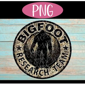 May include: A round, black and white sticker with a camouflage pattern. The sticker says "Bigfoot Research Team" with a silhouette of Bigfoot in the center.