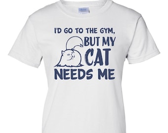 May include: White t-shirt with a blue graphic that says "I'd go to the gym, but my cat needs me". The graphic also includes a cartoon cat.