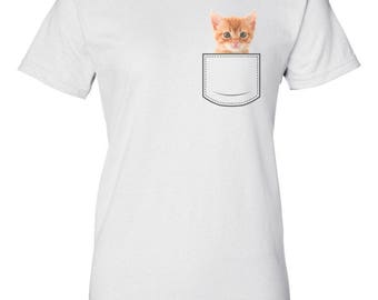 May include: White t-shirt with a small pocket on the front. A cute orange kitten is peeking out of the pocket.