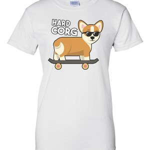 May include: White t-shirt with a cartoon image of a corgi wearing sunglasses and skateboarding. The text "HARD CORG" is printed above the corgi.