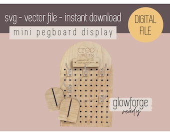May include: A wooden pegboard display with a rounded top and holes for pegs. The pegboard is labeled "creo crafting essential oil bar diffuser 12". The display is ready for use with a Glowforge.