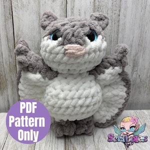 May include: A crocheted bat plush toy in shades of grey and white. The bat features large blue eyes, a pink nose, and small ears. The wings are extended, and the body is a mix of grey and white yarn. A purple circle with the text "PDF Pattern Only" is visible.