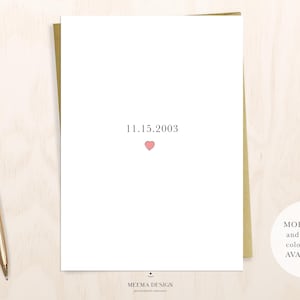 May include: A white card with the date "11.15.2003" printed in black and a small pink heart below the date. The card has the text "MEEMA DESIGN" printed at the bottom.