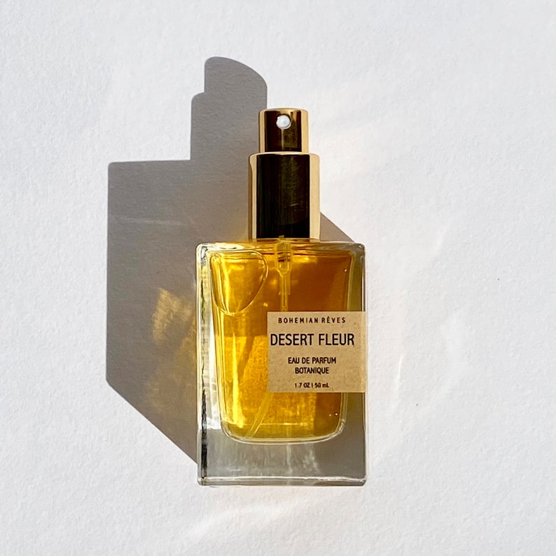 Bohemian Rêves Desert Fleur Perfume Mist—a delicate veil of patchouli and vanilla, evoking golden desert sands and warm, resinous air. A lightweight yet intoxicating scent designed for effortless, all-over wear.