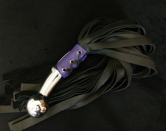 Heavy handled Hame Ball Flogger w/ 32 falls in heavy weight black leather. Including a purple corset under chromed brass