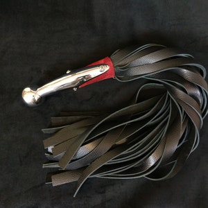 Heavy handled Hame Ball Flogger w/ 30 falls in heavy weight leather. Including a dark red corset under chromed brass