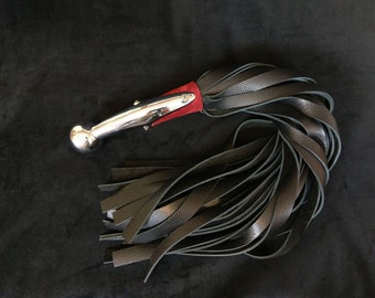 Heavy handled Hame Ball Flogger w/ 30 falls in heavy weight leather. Including a dark red corset under chromed brass