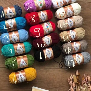 May include: A collection of 17 skeins of yarn in various colors, including red, blue, green, yellow, white, and gray. Each skein is labeled with the brand name "Alize" and a number from 1 to 17.