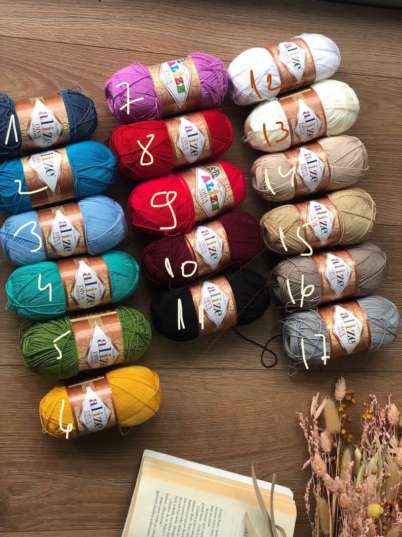 May include: A collection of 17 skeins of yarn in various colors, including red, blue, green, yellow, white, and gray. Each skein is labeled with the brand name "Alize" and a number from 1 to 17.