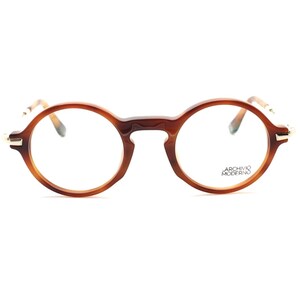 May include: Round eyeglasses with a tortoiseshell pattern frame. The glasses have clear lenses and thin, gold-colored accents at the temples. The brand name "ARCHIVIO MODERNO" is printed on the right lens.