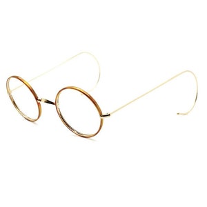 Puede incluir: Gafas redondas con montura de carey marrón y bordes dorados.