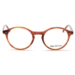 May include: Round, brown eyeglasses with a tortoiseshell pattern. The frames have a classic design with a keyhole bridge and the text "Anglo American" printed on the lower right lens.