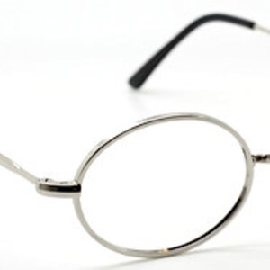 May include: Silver oval-shaped eyeglasses with thin metal frames.