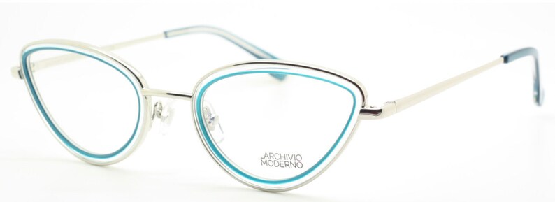May include: Silver cat-eye glasses with a blue trim around the lenses. The brand name "ARCHIVIO MODERNO" is printed on the frame.
