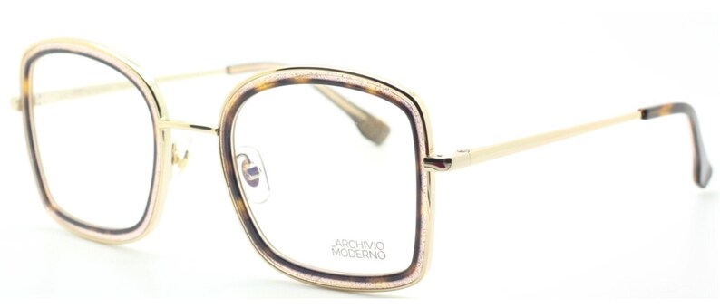 May include: Gold-rimmed eyeglasses with a tortoise shell frame and clear lenses. The frame has a subtle sparkle and the brand name "Archivio Moderno" is printed on the right lens.