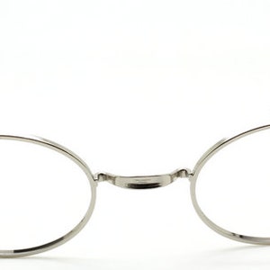 May include: Silver round-framed glasses with thin metal arms.