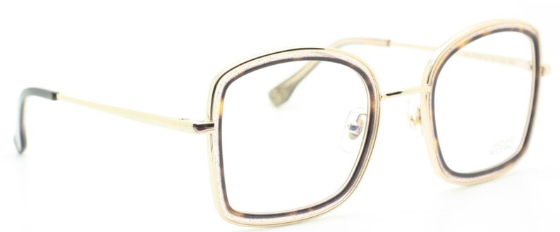 May include: Gold-tone eyeglasses with a square frame and clear lenses. The frame has a subtle sparkle detail.