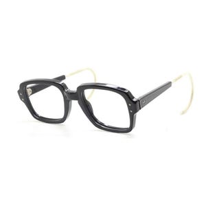 May include: Black plastic framed glasses with clear lenses and white plastic side arms.