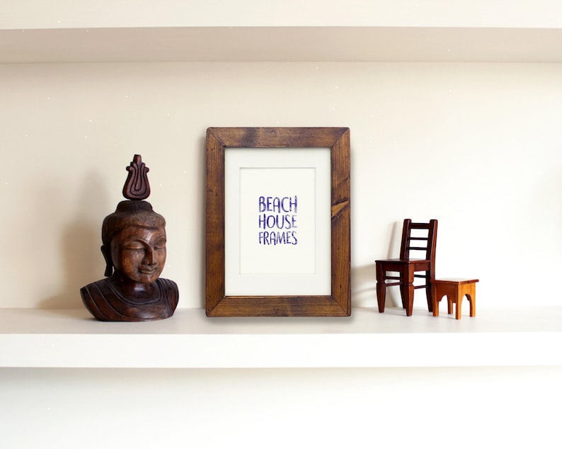 a wooden shelf with a framed picture, a wooden statue, and a small wooden chair.