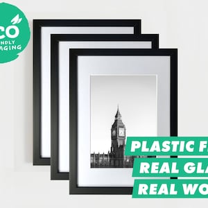 May include: Three black picture frames with real glass and real wood, stacked on top of each other. The smallest frame has a black and white photo of Big Ben in London.