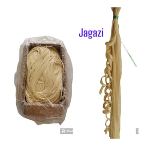 May include: A box of light brown, dried noodles with a clear plastic bag over the top. The box is labelled "Jagazi".