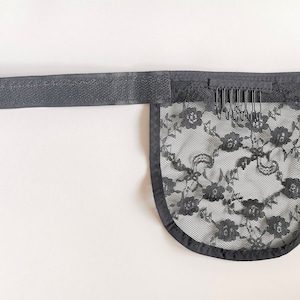 May include: Black lace wig cap with an adjustable strap and combs. The cap is made of a soft, breathable material and is designed to fit comfortably on the head.