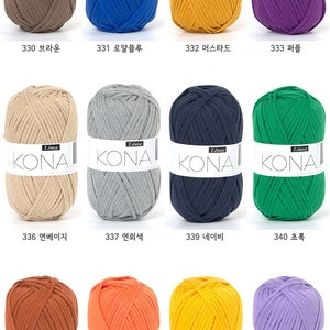 May include: A collection of 10 balls of yarn in various colors, including brown, blue, yellow, purple, beige, gray, navy, green, orange, and lavender. Each ball of yarn has a label that reads "Linea Kona".