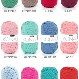 May include: A collection of 10 balls of yarn in various colors, including green, brown, red, burgundy, pink, blue, and turquoise. Each ball has a white label with the word "KONA" and a number. The numbers range from 315 to 329.