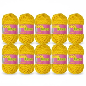 May include: Ten skeins of bright yellow wool yarn are arranged in two rows. Each skein has a pink label with the text "WOOL BEAR" and "Gr 15". The yarn is tightly wound, suggesting it's suitable for knitting or crochet projects.