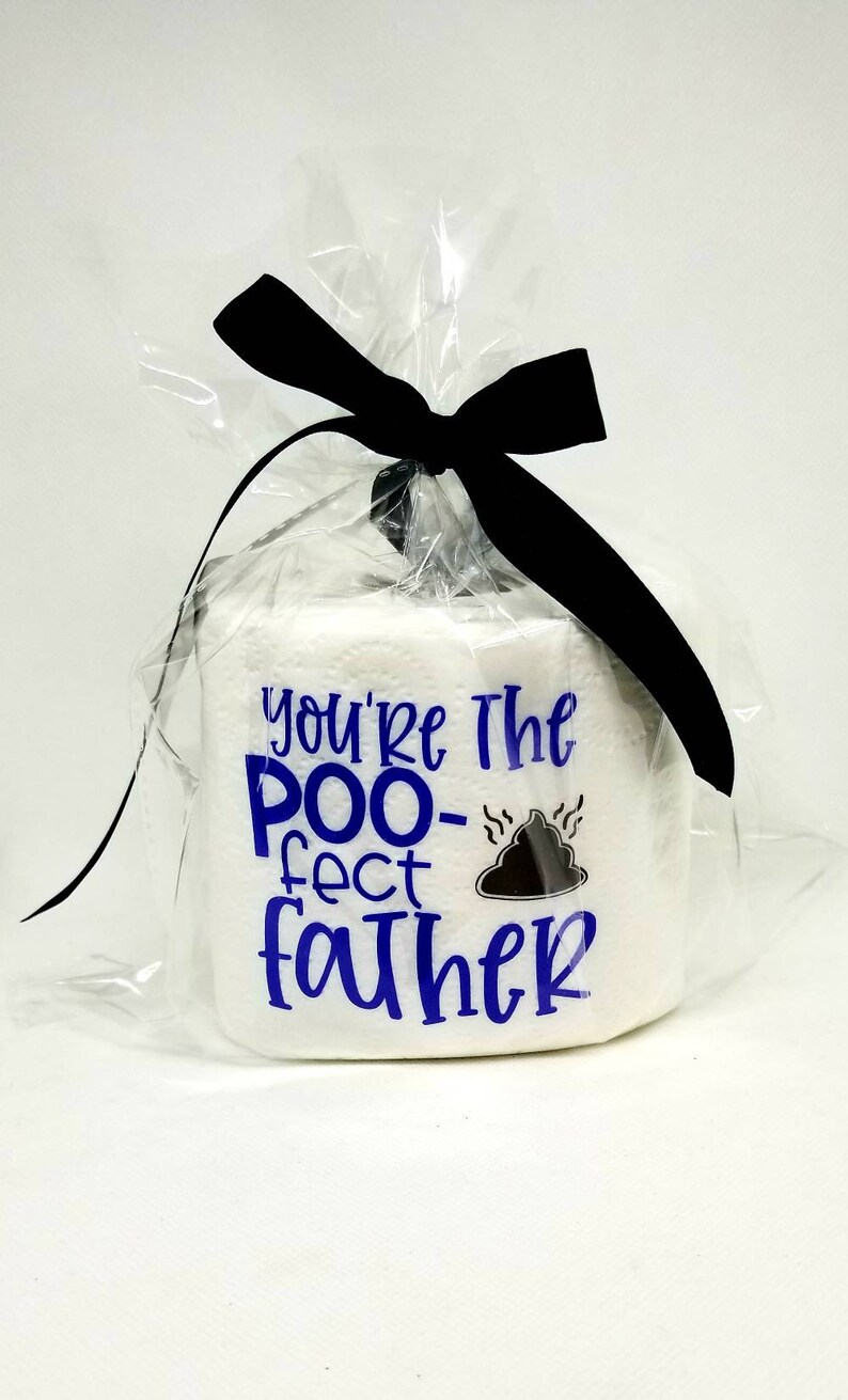 May include: A white toilet paper roll wrapped in clear cellophane and tied with a black bow. The roll has blue text that reads "You're The POO-fect FATHER" with a graphic of a pile of poop.
